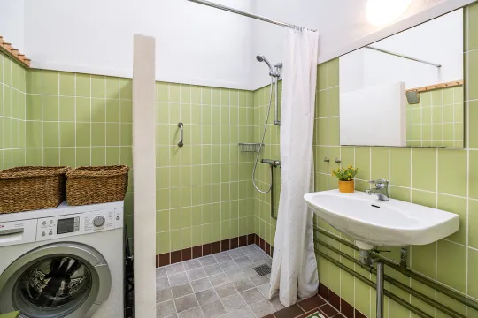 Badeværelse med brus, wc, håndvask og vaskemaskine i Hammershus 122