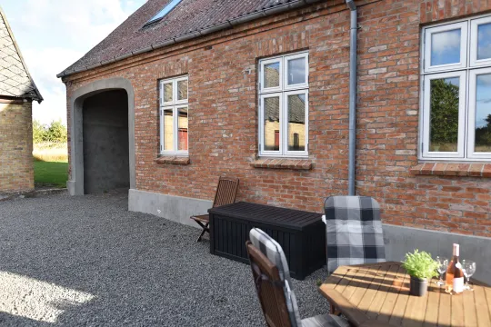 Hyggelig gårdsplads med havemøbler ved ferielejlighed Nyvang A